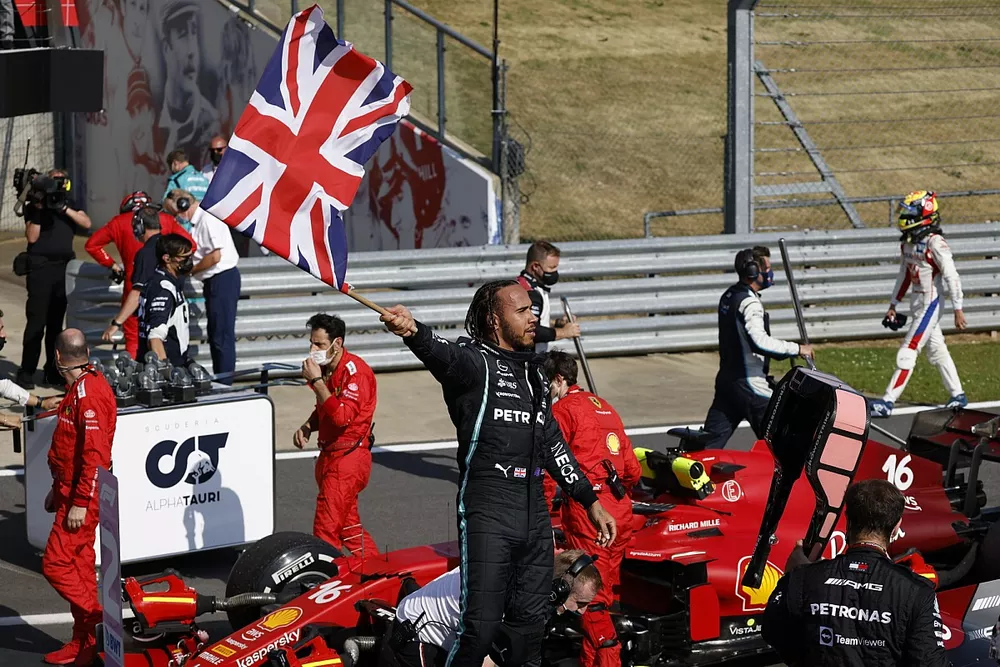 Lewis Hamilton, Mercedes, 1st position, celebrates after the race whilst parading the Union flag