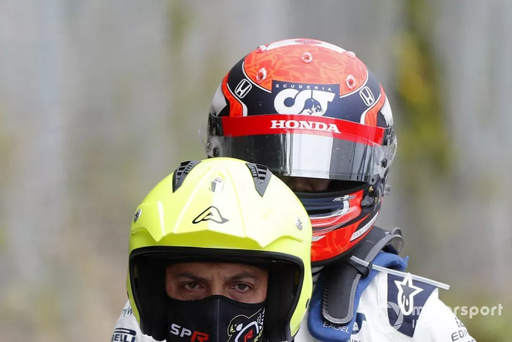 Yuki Tsunoda, AlphaTauri, gets a lift back to the pits after retiring from the race