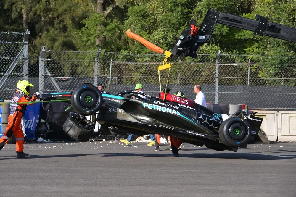 Marshals remove the damaged car of George Russell, Mercedes F1 W15, from the circuit after a crash in FP2