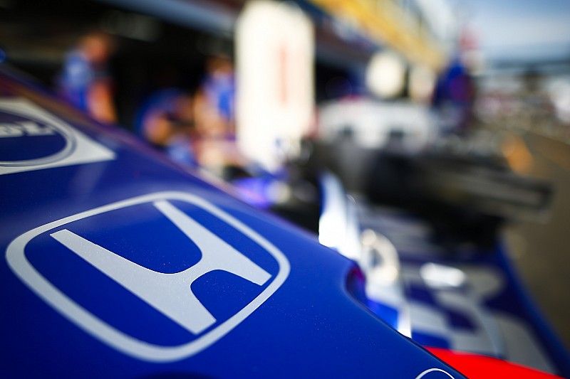 A Honda logo on the nose of a Toro Rosso in the pit lane