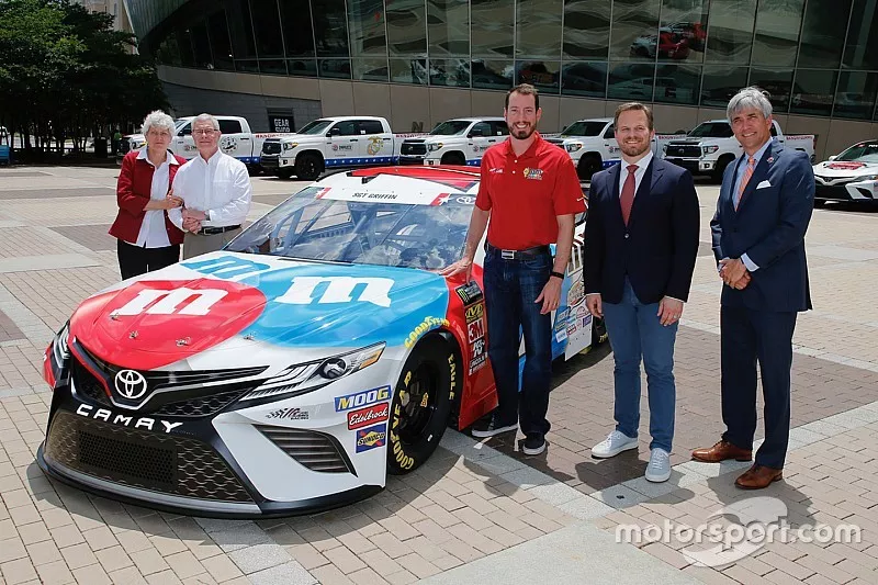 Dona and Gene Griffin, the parents of fallen U.S. Army Sgt. Dale Griffin, join defending Coca-Cola 600 winner Kyle Busch, Speedway Motorsports, Inc. President and CEO Marcus Smith and Charlotte Motor Speedway Executive Vice President and General Manager Greg Walter in unveiling Busch's patriotic paint scheme for the 60th Coca-Cola 600 in a special event on Wednesday at the NASCAR Hall of Fame