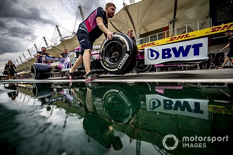 Racing Point mechanics pushing the car of Sergio Perez, Racing Point RP19 down the pit lane