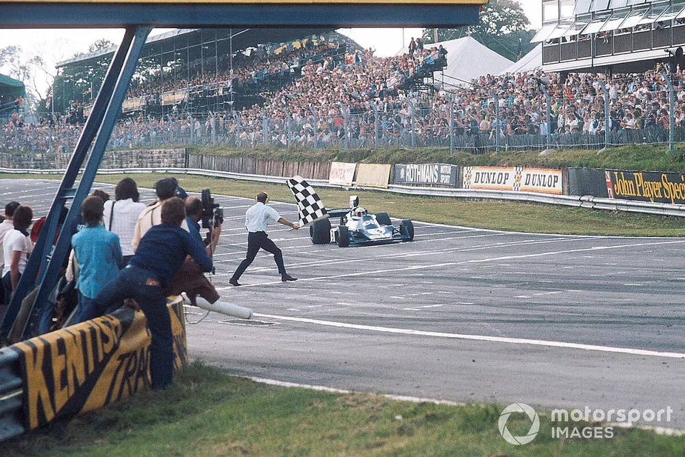 Jody Scheckter, Tyrrell 007 Ford, takes the chequered flag for 1st position
