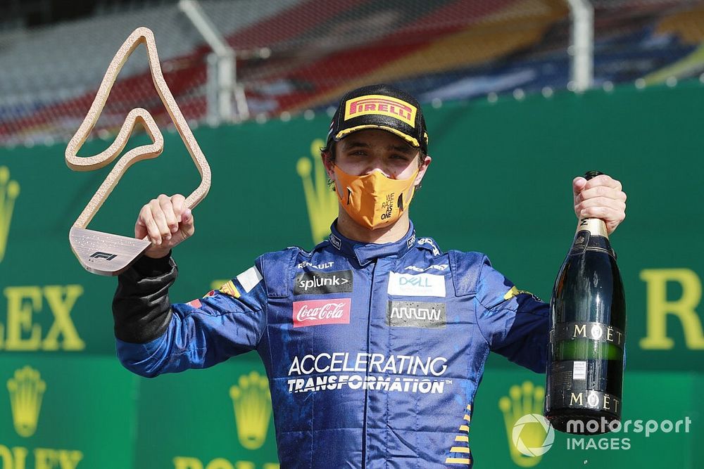 Lando Norris, McLaren, celebrates with his trophy and champagne