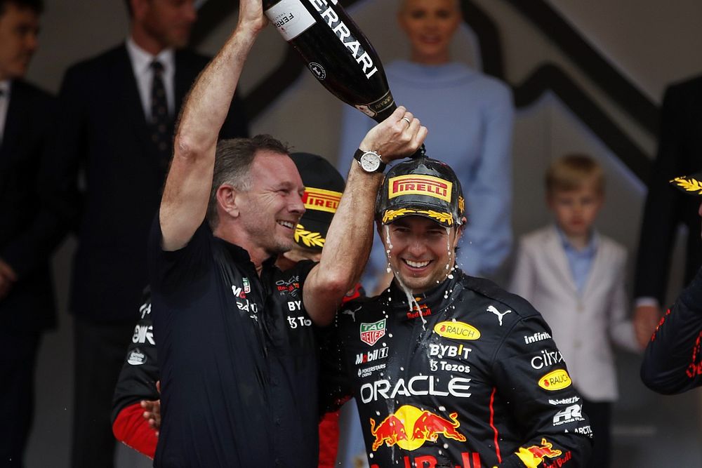 Christian Horner, director del equipo Red Bull Racing, vierte champán sobre Sergio Pérez, Red Bull Racing, 1ª posición, en el podio