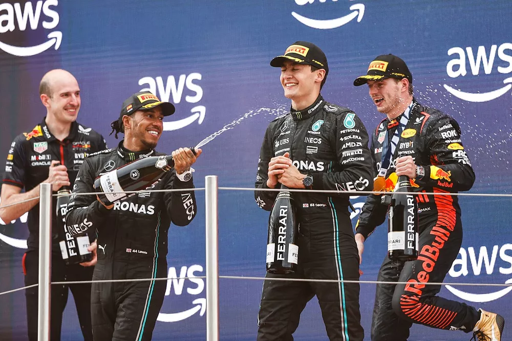 Lewis Hamilton, Mercedes-AMG, 2nd position, George Russell, Mercedes-AMG, 3rd position, Max Verstappen, Red Bull Racing, 1st position, celebrate on the podium with Champagne