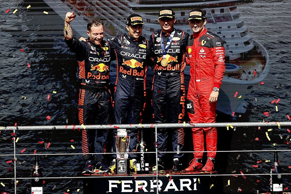 The Red Bull trophy delegate, Sergio Perez, Red Bull Racing, 2nd position, Max Verstappen, Red Bull Racing, 1st position, and Charles Leclerc, Scuderia Ferrari, 3rd position, on the podium
