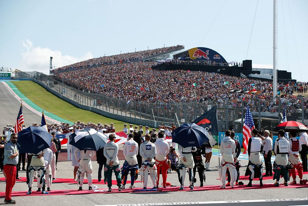 The drivers line up for the national anthem prior to the start