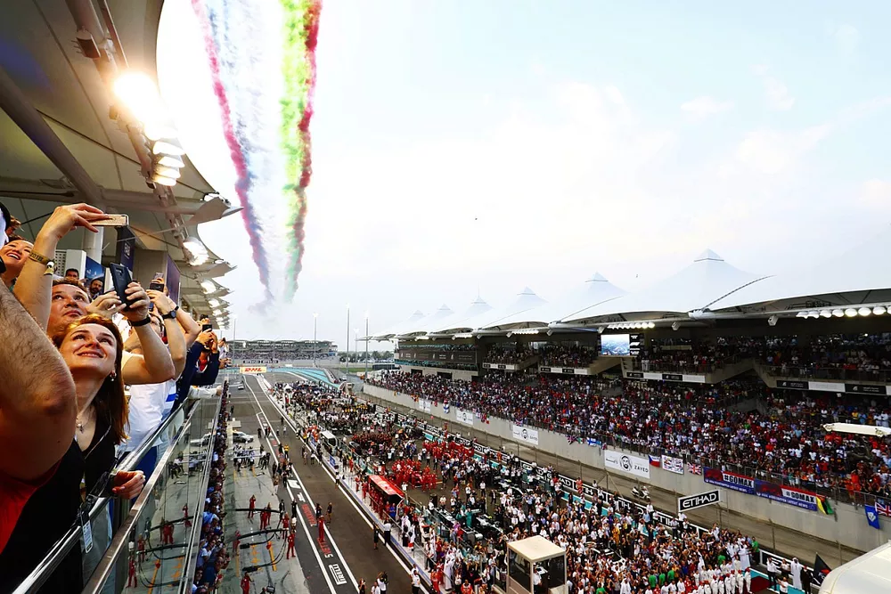 Fans look up as display smoke hangs in the air from the flypast