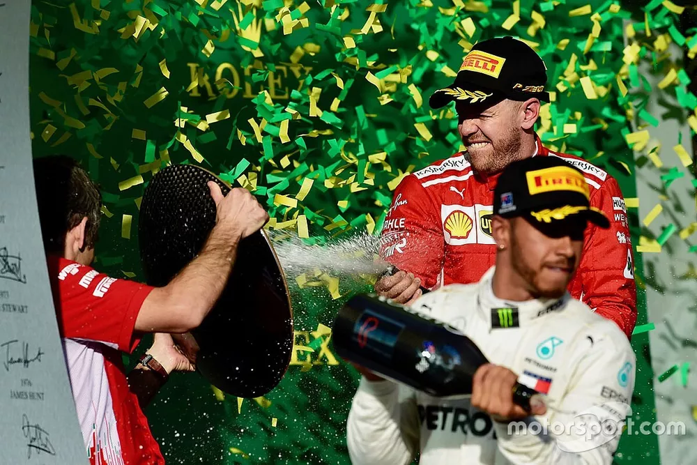 Lewis Hamilton, Mercedes-AMG F1 and Sebastian Vettel, Ferrari celebrate on the podium with the champ