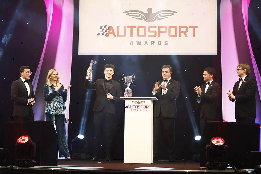 Zak O'Sullivan, Aston Martin Autosport BRDC Young Driver of the Year Award winner on stage with his trophy 