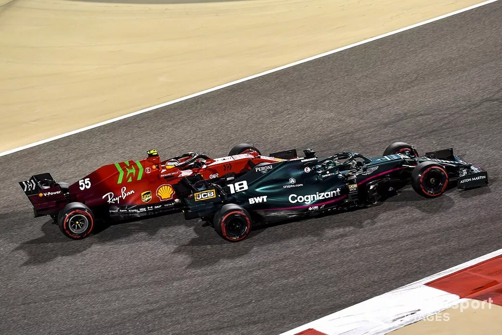 Lance Stroll, Aston Martin AMR21, passes Carlos Sainz Jr., Ferrari SF21