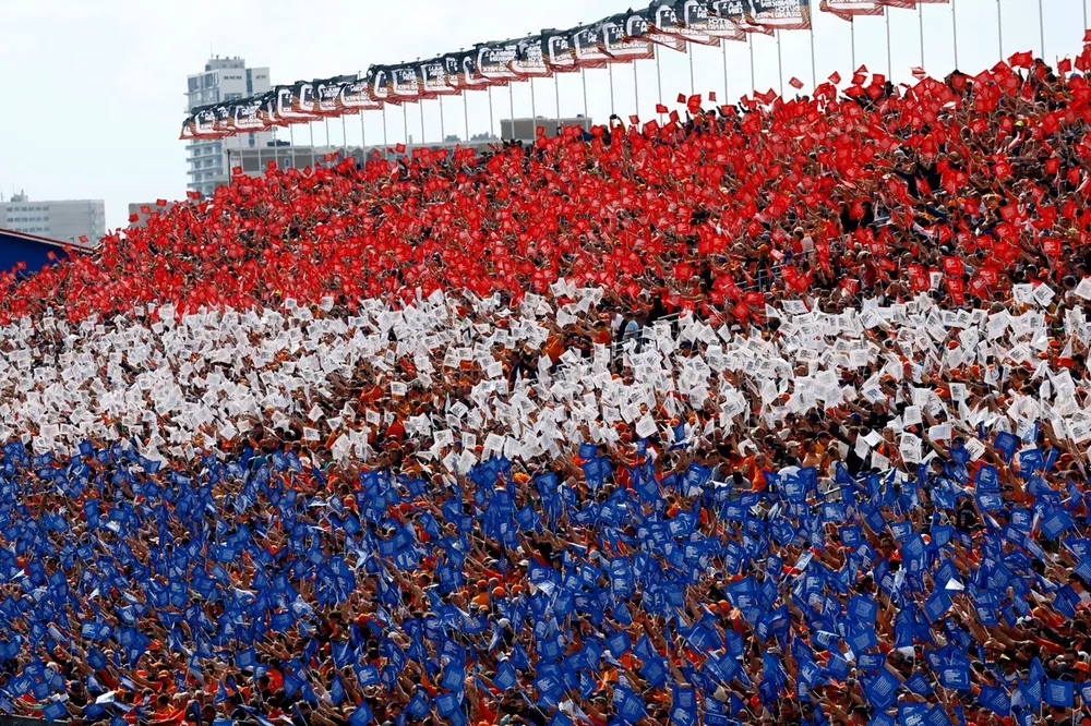 Fans form the Dutch colours in a grandstand