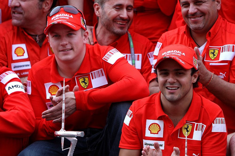 Kimi Raikkonen, Felipe Massa and Scuderia Ferrari team members celebrate win and second place