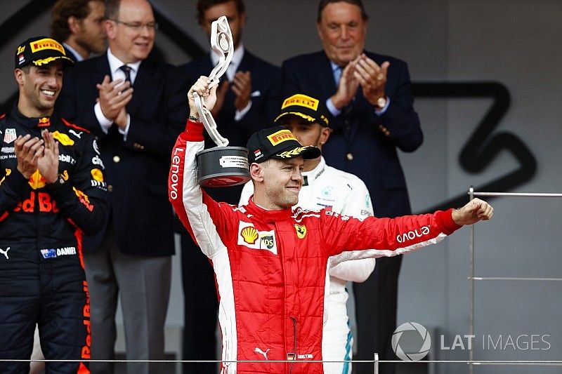 Sebastian Vettel, Ferrari, raises his second place trophy