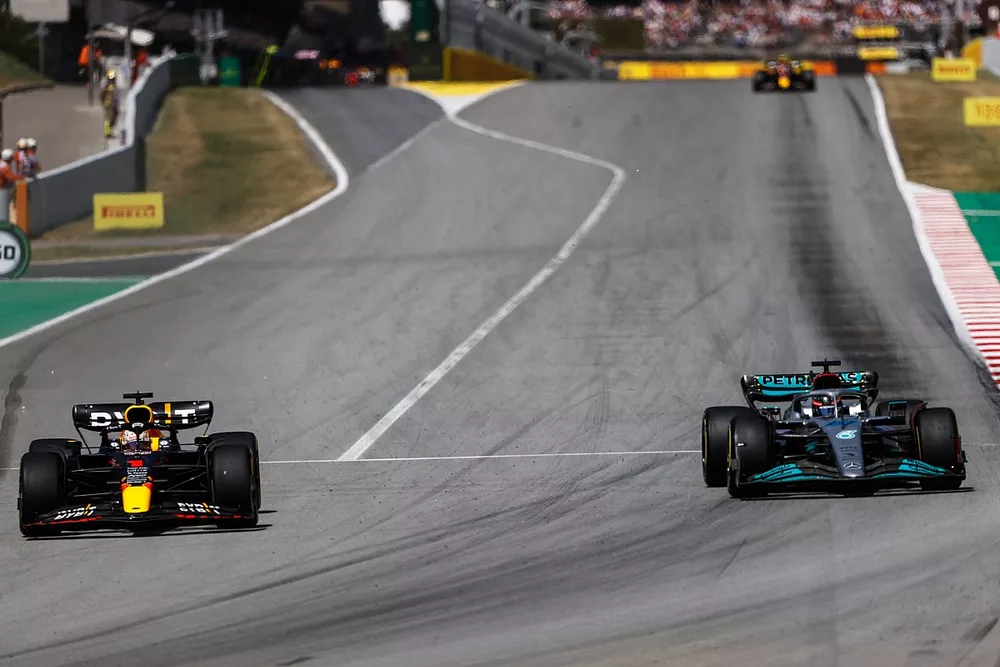 Max Verstappen, Red Bull Racing RB18, passes George Russell, Mercedes W13 