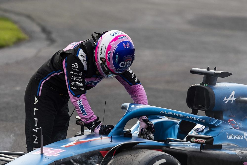 Fernando Alonso, Alpine F1 Team, climbs out of his car after retiring from the race