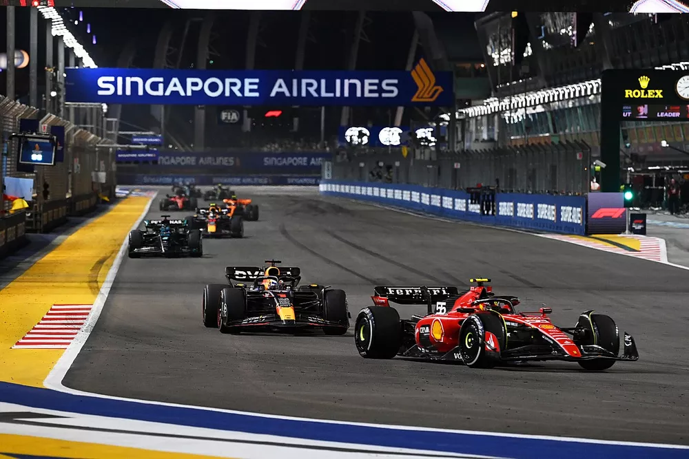 Carlos Sainz, Ferrari SF-23, leads Max Verstappen, Red Bull Racing RB19, and George Russell, Mercedes F1 W14