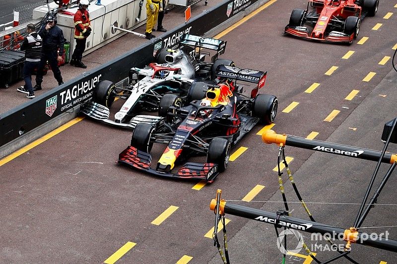 Max Verstappen, Red Bull Racing RB15, and Valtteri Bottas, Mercedes AMG W10, battle in the pit lane