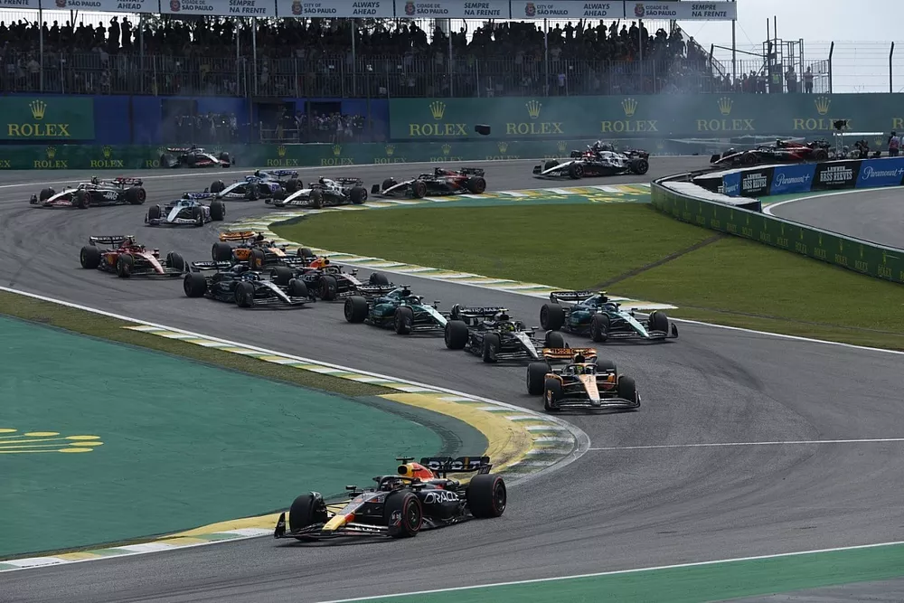 Max Verstappen, Red Bull Racing RB19, Lando Norris, McLaren MCL60, Lewis Hamilton, Mercedes F1 W14, Fernando Alonso, Aston Martin AMR23, Lance Stroll, Aston Martin AMR23, the rest of the field at the start as Kevin Magnussen, Haas VF-23, Alex Albon, Williams FW45, crash in the background
