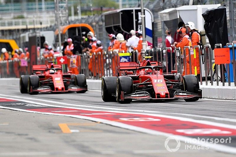 Charles Leclerc, Ferrari SF90, leads Sebastian Vettel, Ferrari SF90, in the pit lane