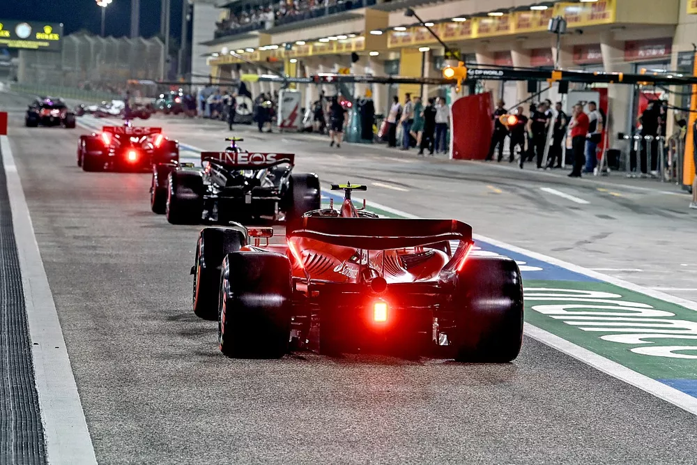 Lewis Hamilton, Mercedes F1 W14, Carlos Sainz, Ferrari SF-23, in the pit lane