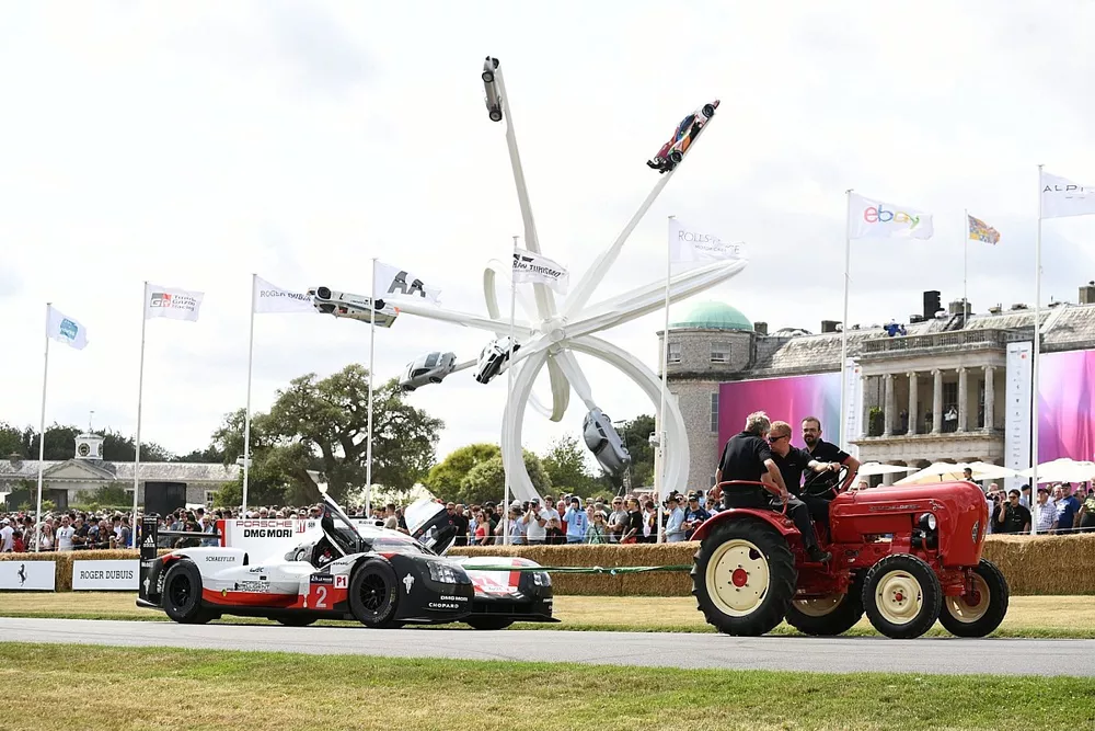 A tractor pulls a Porsche 919