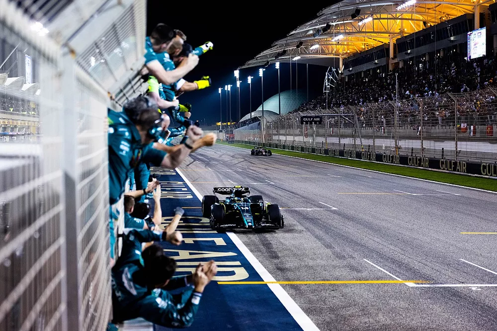 The Aston Martin team cheer Fernando Alonso, Aston Martin AMR23, 3rd position, over the line