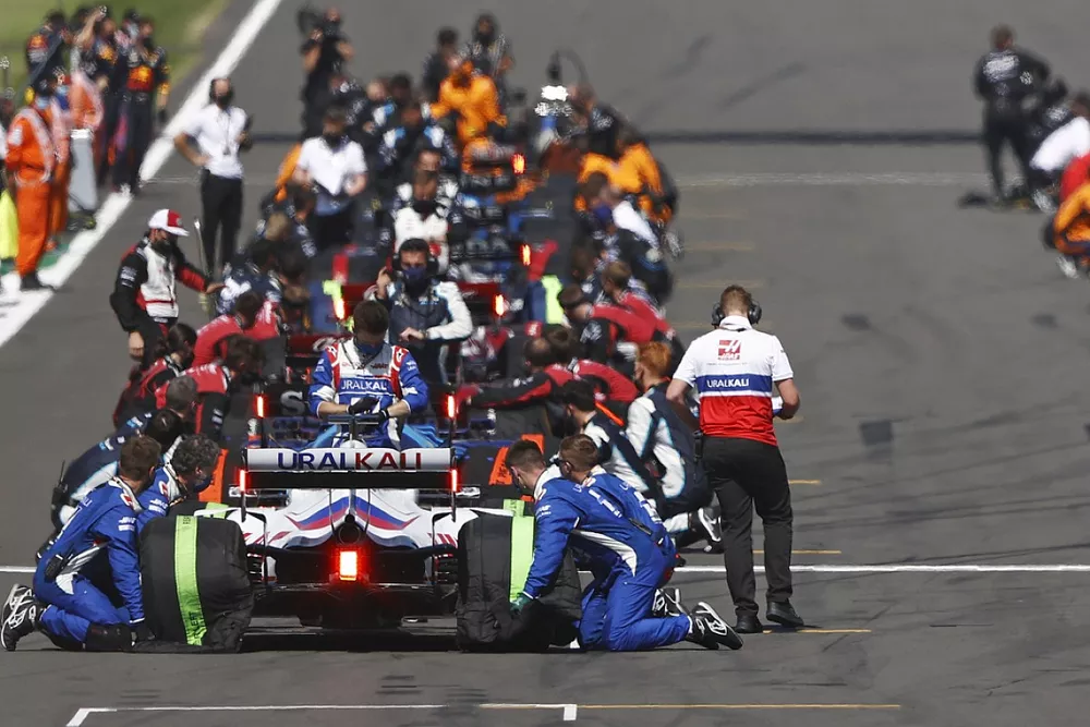 Mechanics make final preparations on the grid prior to the start