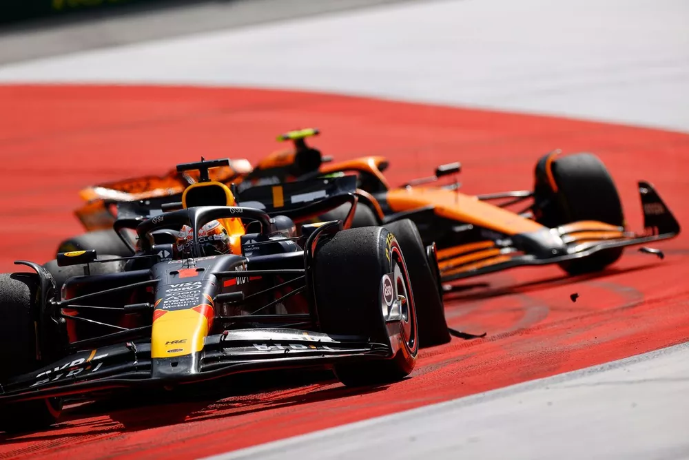 Max Verstappen, Red Bull Racing RB20, leads Lando Norris, McLaren MCL38, after the pair have made contact. Verstappen drives with a damaged wheel and puncture