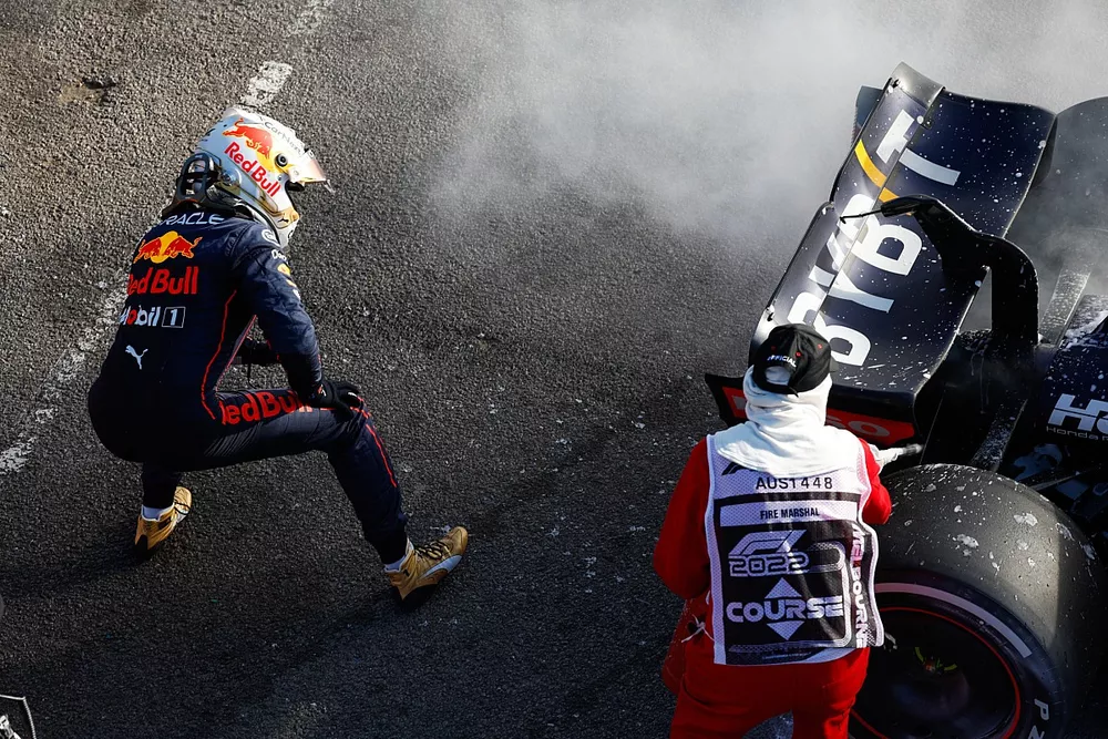 Max Verstappen, Red Bull Racing, retires from the race and a marshal assists with a fire