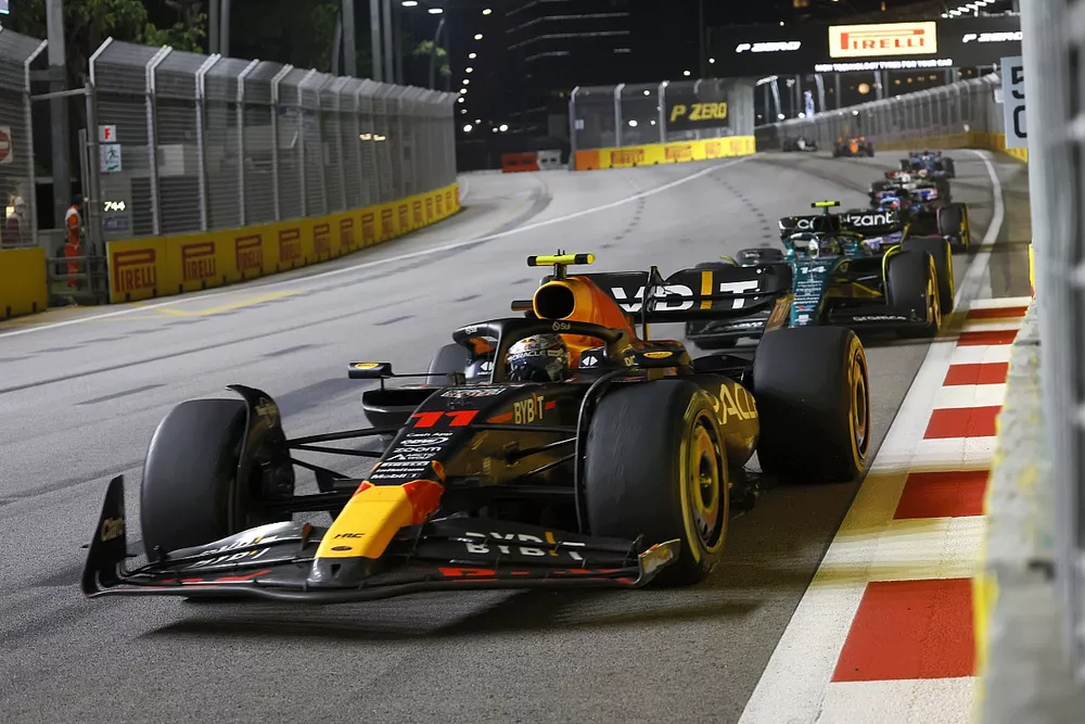 Sergio Perez, Red Bull Racing RB19, leads Fernando Alonso, Aston Martin AMR23