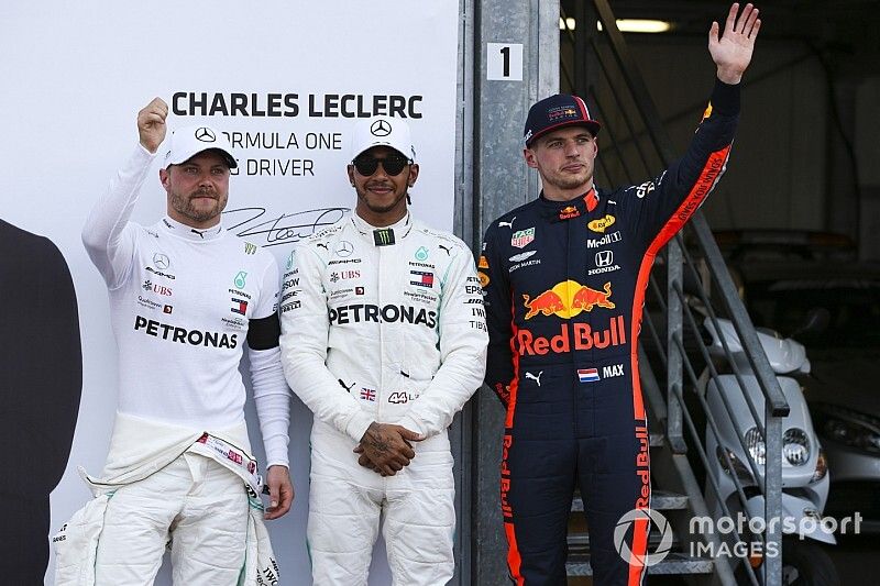 Lewis Hamilton, Mercedes AMG F1, celebrates pole position, alongside Valtteri Bottas, Mercedes AMG F1, and Max Verstappen, Red Bull Racing 