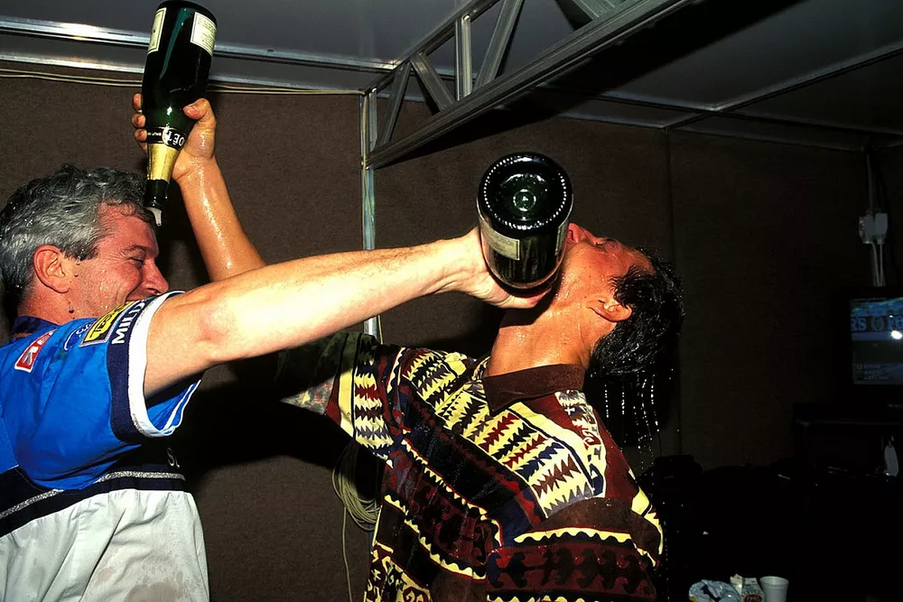 Michael Schumacher, Benetton celebrates winning the Formula 1 World Championship with his race engin