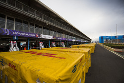 DHL crates in the pit lane