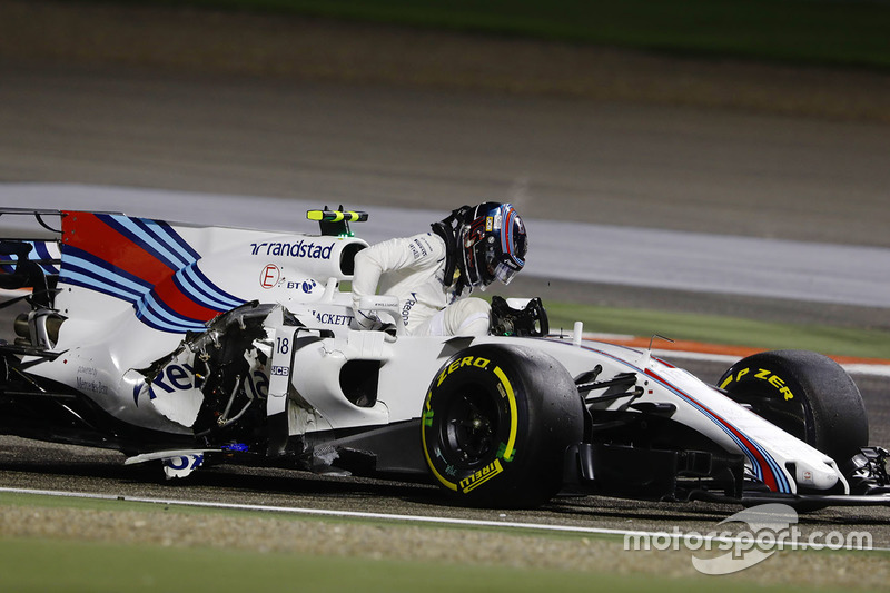 Lance Stroll, Williams FW40, climbs from his crashed car