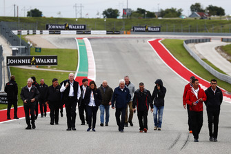 Charlie Whiting, Race Director, FIA, walks the track with his team