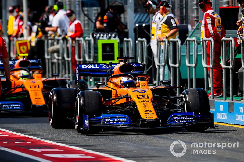 Carlos Sainz Jr., McLaren MCL34, leads Lando Norris, McLaren MCL34, in the pit lane