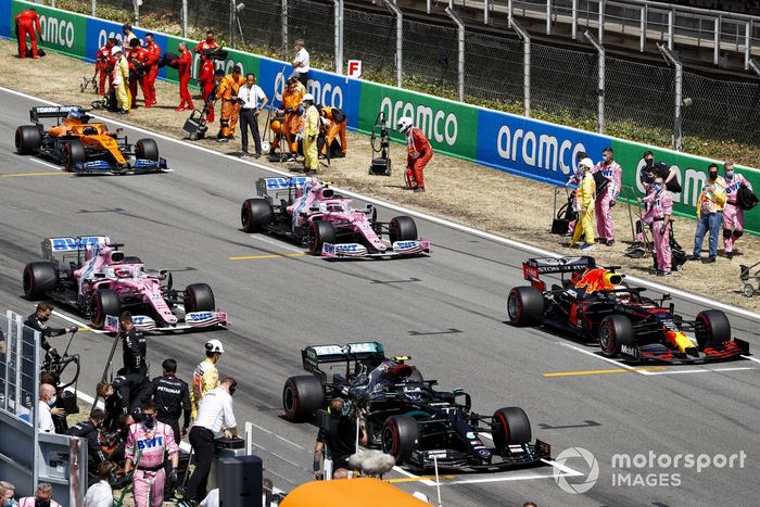 Los mecánicos despejan la parrilla mientras Valtteri Bottas, Mercedes F1 W11 EQ Performance, Max Verstappen, Red Bull Racing RB16, Sergio Pérez, Racing Point RP20, Lance Stroll, Racing Point RP20, Carlos Sainz Jr., McLaren MCL35, se preparan para iniciar la vuelta de formación