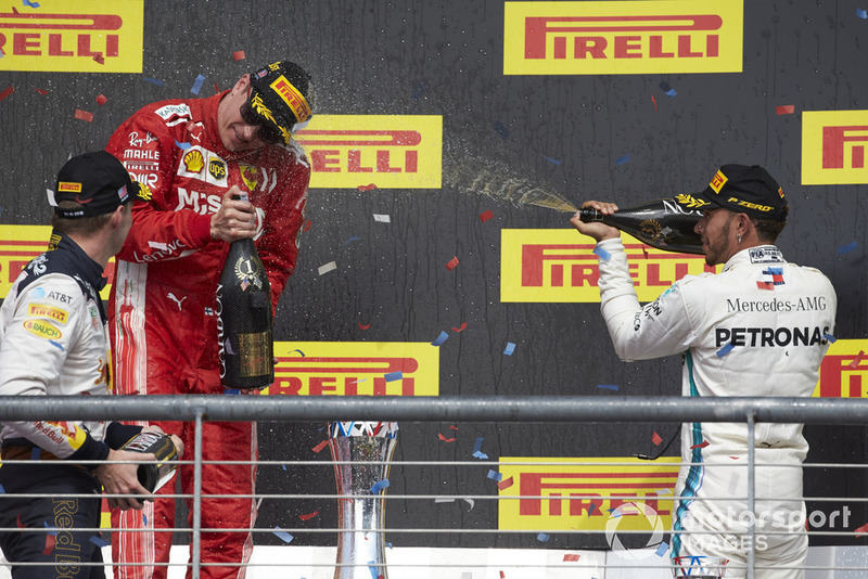 Max Verstappen, Red Bull Racing, 2nd position, and Lewis Hamilton, Mercedes AMG F1, 3rd position, spray Kimi Raikkonen, Ferrari, 1st position, with Champagne on the podium