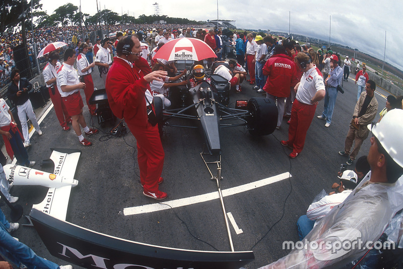 Ayrton Senna, McLaren MP4/6 Honda, sits in pole position on the grid, with team boss Ron Dennis and 