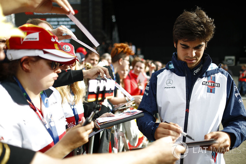 Lance Stroll, Williams Racing, signs autographs for fans