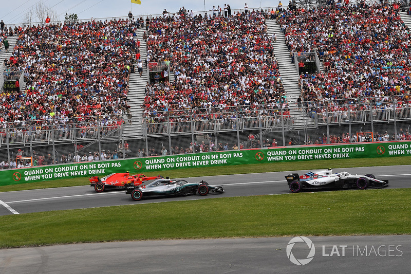 Kimi Raikkonen, Ferrari SF71H exits pit lane behind Lewis Hamilton, Mercedes-AMG F1 W09