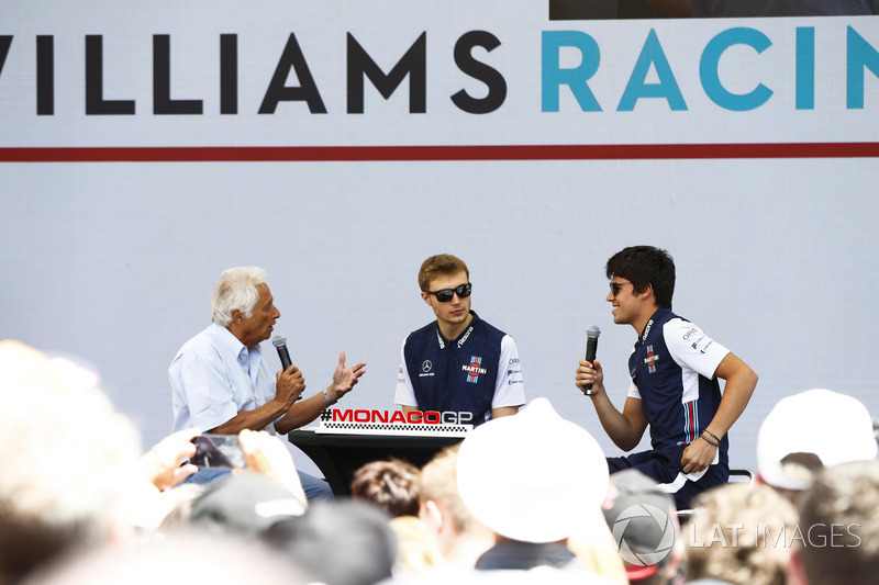 Bob Constanduros talks to Lance Stroll, Williams Racing, and Sergey Sirotkin, Williams Racing, on stage