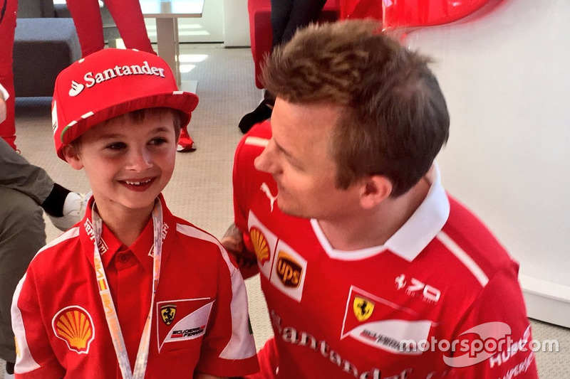 Kimi Raikkonen, Ferrari with Thomas, a young fan