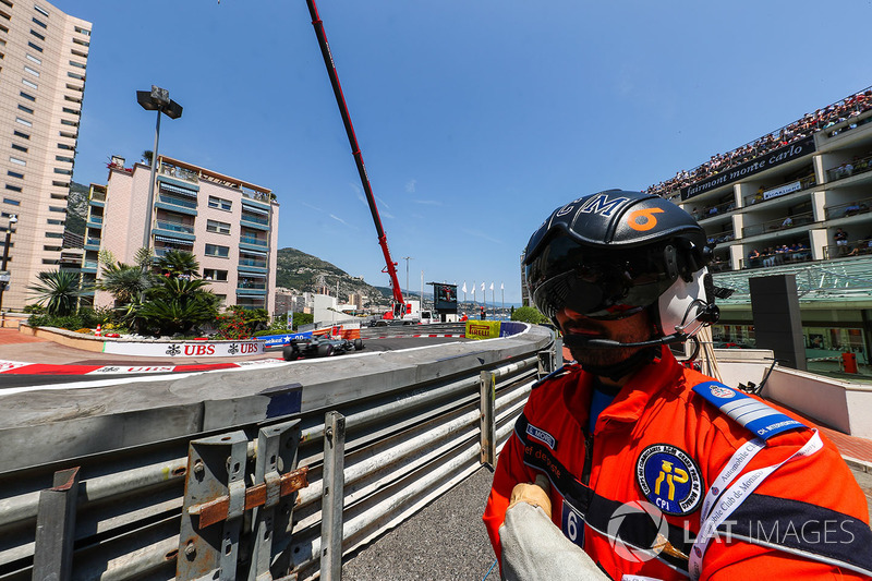 Marshal watches Kevin Magnussen, Haas VF-17