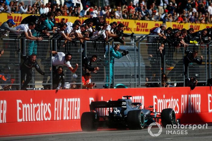 Lewis Hamilton, Mercedes AMG F1 W10, is greeted by his team at the finish