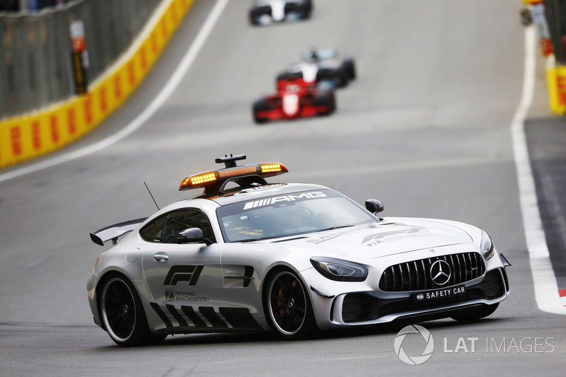 The Safety Car leads Sebastian Vettel, Ferrari SF71H, and Lewis Hamilton, Mercedes AMG F1 W09