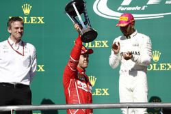 Second place Sebastian Vettel, Ferrari, lifts his trophy on the podium