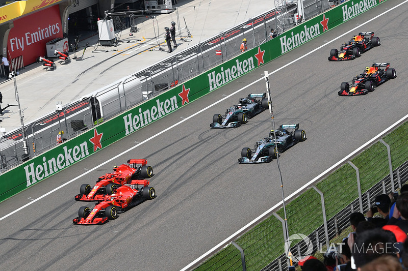 Sebastian Vettel, Ferrari SF71H and Kimi Raikkonen, Ferrari SF71H lead at the start of the race